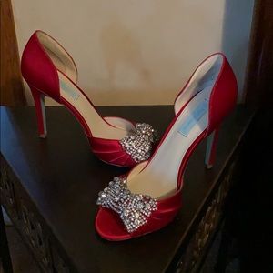 Red satin high heels with rhinestone bow